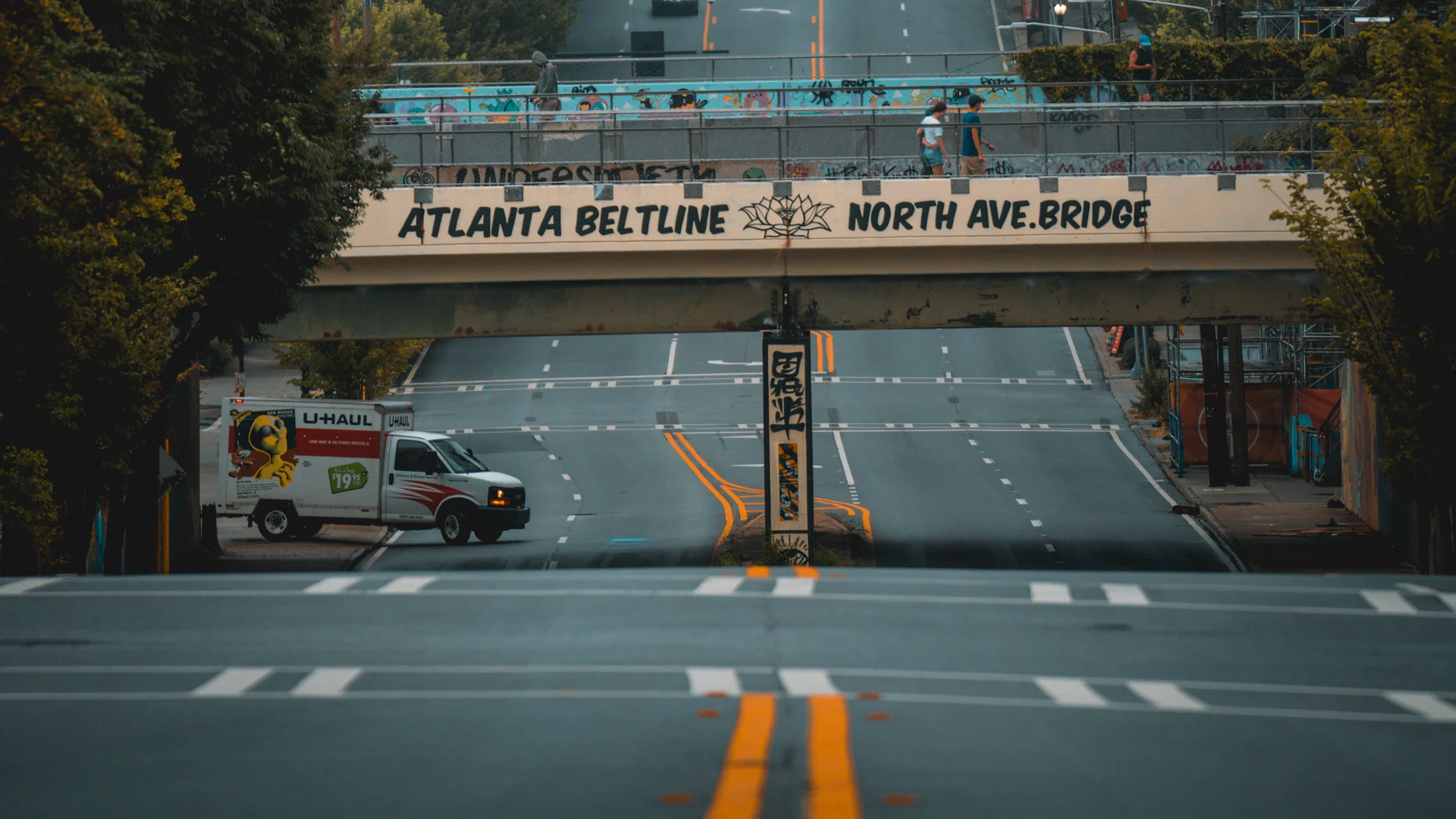 Atlanta street, traffic lights, trees, and skyline viewed from a BeltLine bridge