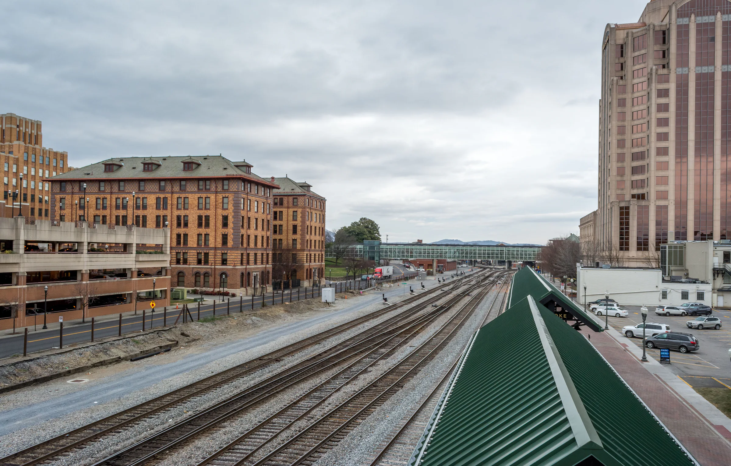 Elevated view along Atlanta rail tracks between historic and modern buildings